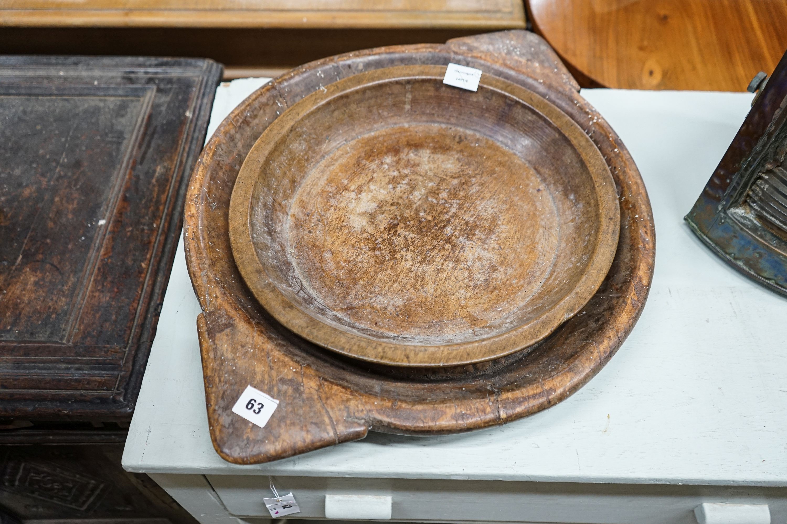 An early 19th century sycamore shallow bowl with lug handles, 64cm and two other bowls, 40cm and 26cm